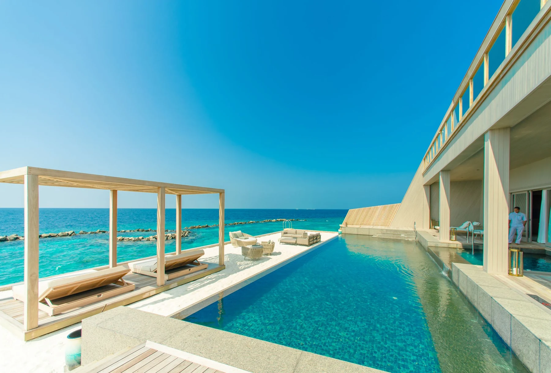 Infinity pool and outdoor lounge overlooking the sea