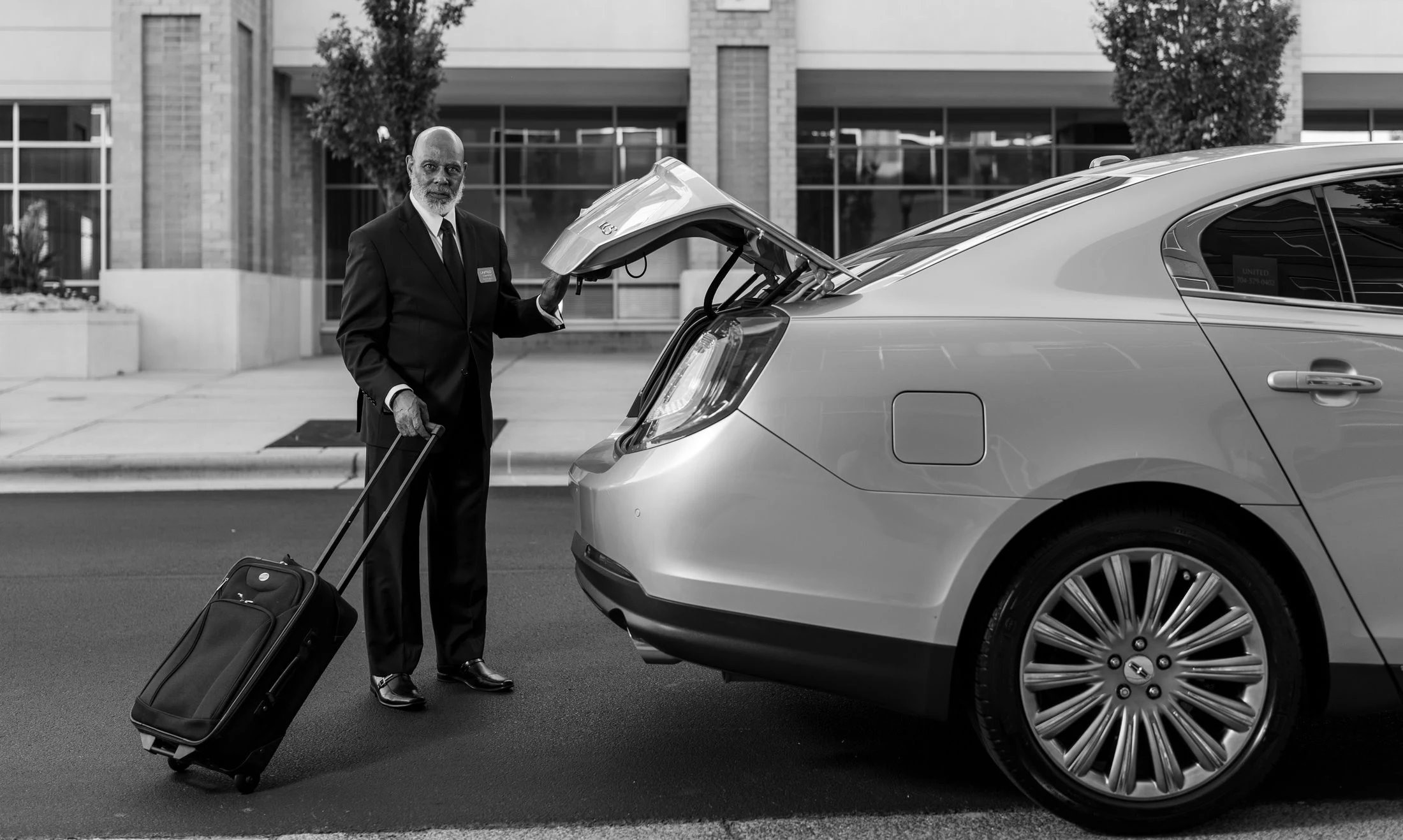 Chauffeur loading luggage into a car