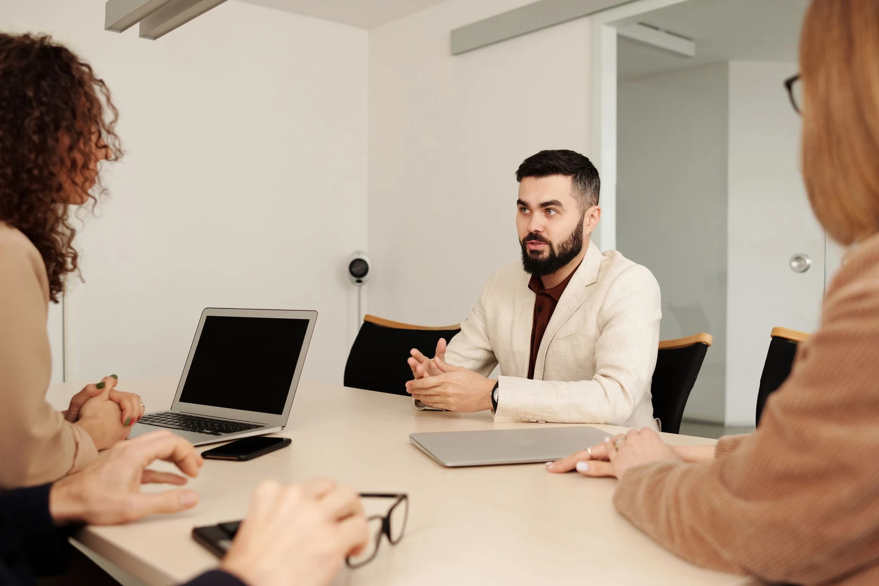 Business professionals discussing arrangements in a light-filled office